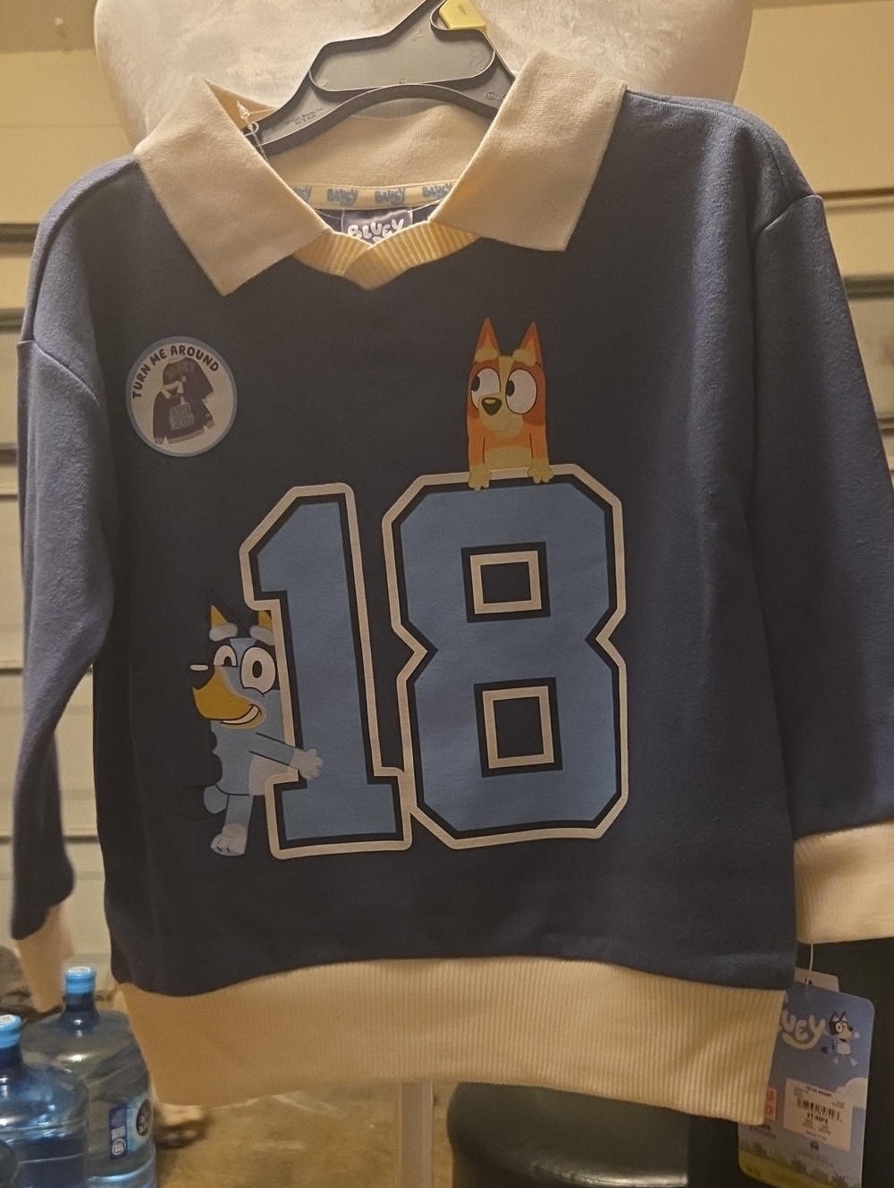 Blue Kids Sweatshirt with '18' Cartoon Graphic and Cream Collar